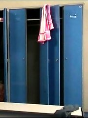 Slim young doll disrobes in a big locker room