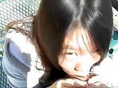 Asian lady inhaling guys in the park in broad day light