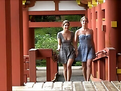 Lesbian couple kissing and demonstrating at a Japanese temple