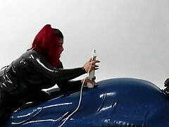 Domina wearing Latex torturing pent up Slave in Rubber Vacuum Bed VacBed