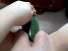 Slut takes massive cucumber in her pussy