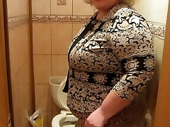 Mature woman with a wooly by a snatch, pissing in the toilet)