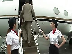 Beautiful stewardess is drilling with 2 businessmen on the board of a plane