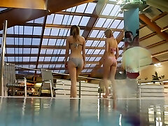Two white young sexy chicks dive in the pool and undress on webcam