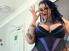 Plumper MiLF with fat tits and tattoos gives pierced cock a hand job.