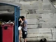 Teens Poke Behind A Dumpster In Public