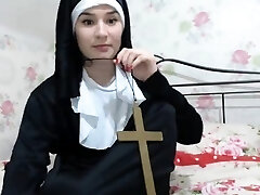 Sexy gal is dressed as a nun and teases to display a little 