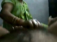 Mature and happy Indian aunty providing oily handjob on cam