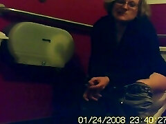Mature unsuspecting female sitting on a toilet