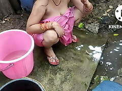 Indian building wife bathing outside