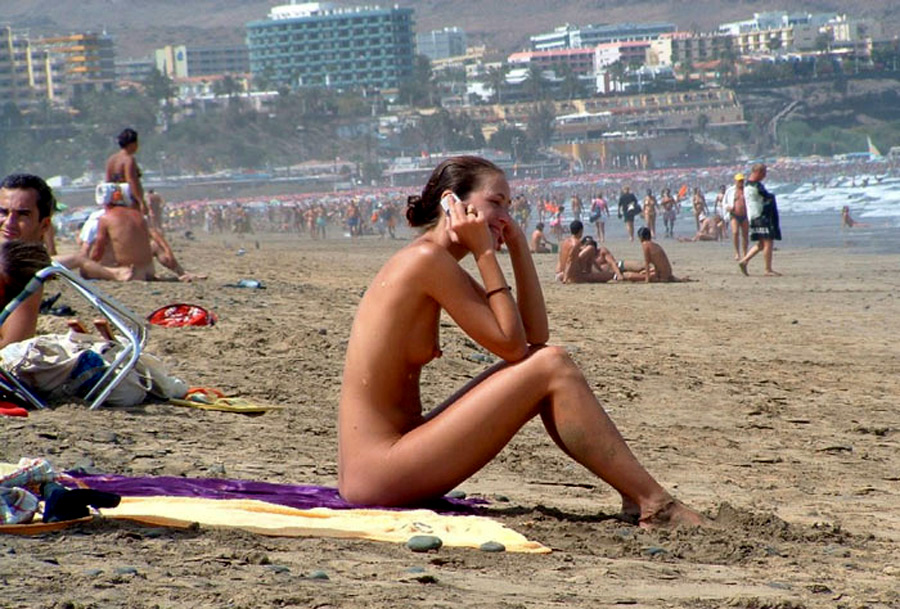 Perfect babes sunbathes nude on the beach photo