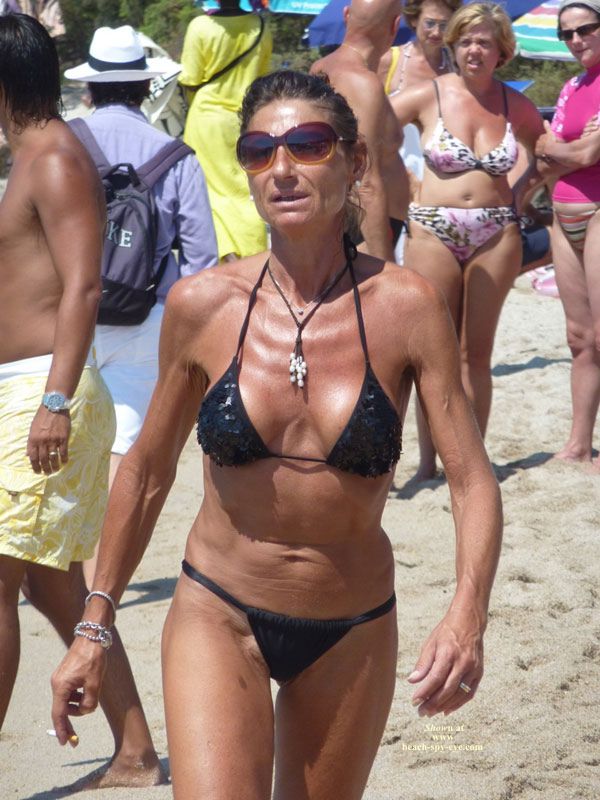 Nude mature women at nudist beach photo