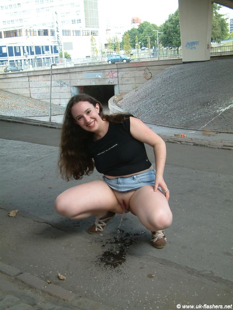 Brunette toying and peeing in public pic
