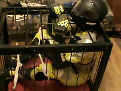 Caged bikerslave in full biker gear