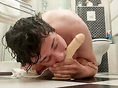 Boy deepthroats a dildo straight out of the shower