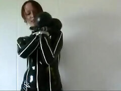 Redhead in strenuous rubber and metal cuffs