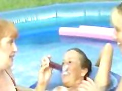 Amateur mature backyard lesbians take turns playing with pussies in a pool